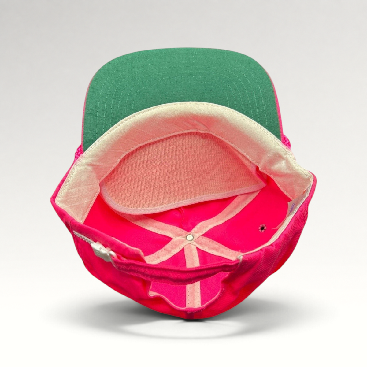 Raree Finds vintage 1980s neon pink zipperback hat with a green undervisor and interior structure detail