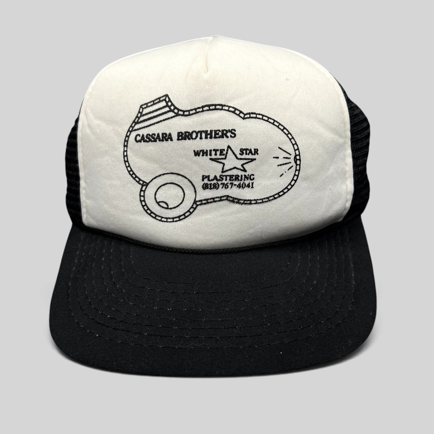 Raree Finds vintage Cassara Brothers White Star Plastering trucker hat with black mesh back and foam front panel.