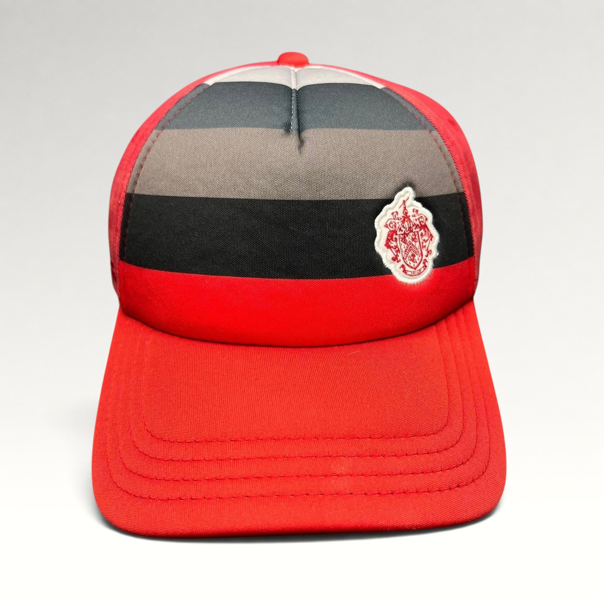 Raree Finds vintage Pukka Headwear red golf hat with black and gray striped front panel and embroidered crest patch