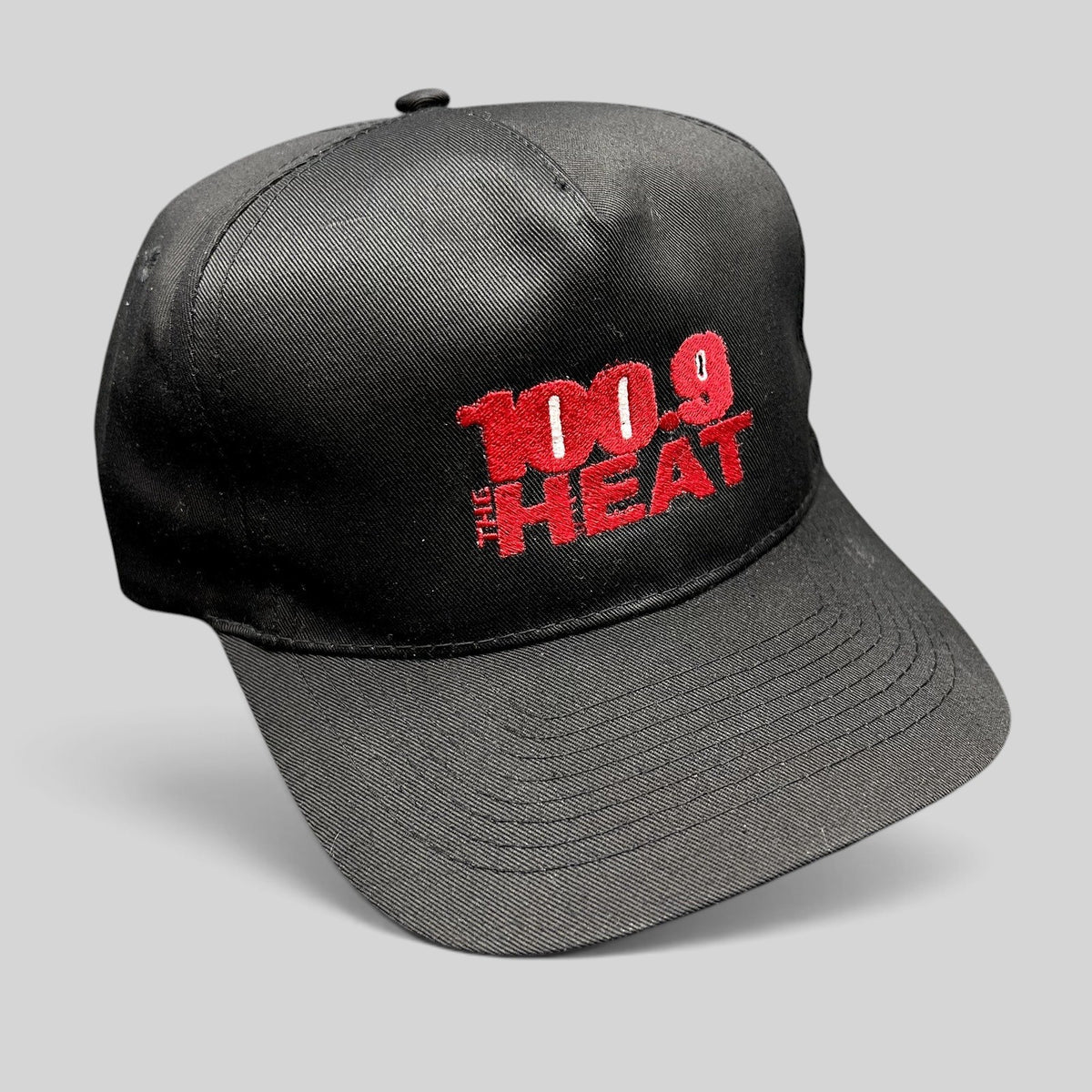 Raree Finds vintage 90s 100.9 The Heat radio station snapback hat with red embroidery on a black structured crown.