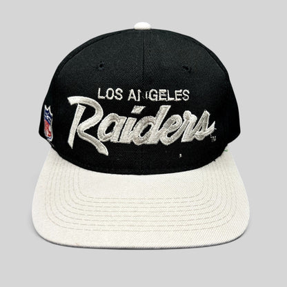 Raree Finds vintage Los Angeles Raiders Sports Specialties snapback hat with black crown, white brim, and script logo.