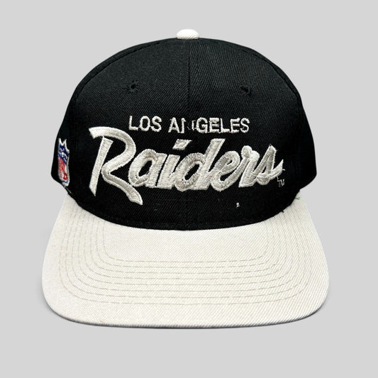 Raree Finds vintage Los Angeles Raiders Sports Specialties snapback hat with black crown, white brim, and script logo.
