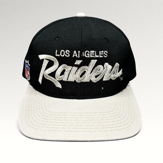 Raree Finds vintage Los Angeles Raiders Sports Specialties snapback hat with black crown, white brim, and script logo.