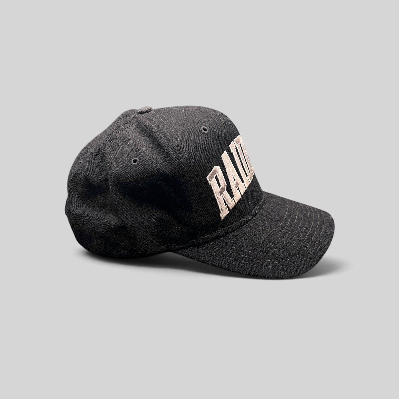 Raree Finds vintage 1990s Starter Los Angeles Raiders wool snapback hat in black with silver arch logo embroidery.