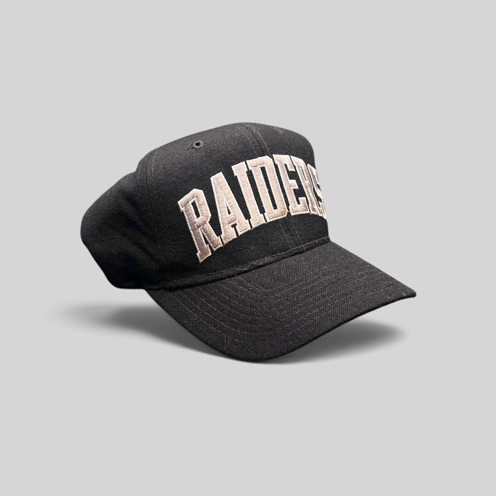 Raree Finds vintage 1990s Starter Los Angeles Raiders wool snapback hat in black with silver arch logo embroidery