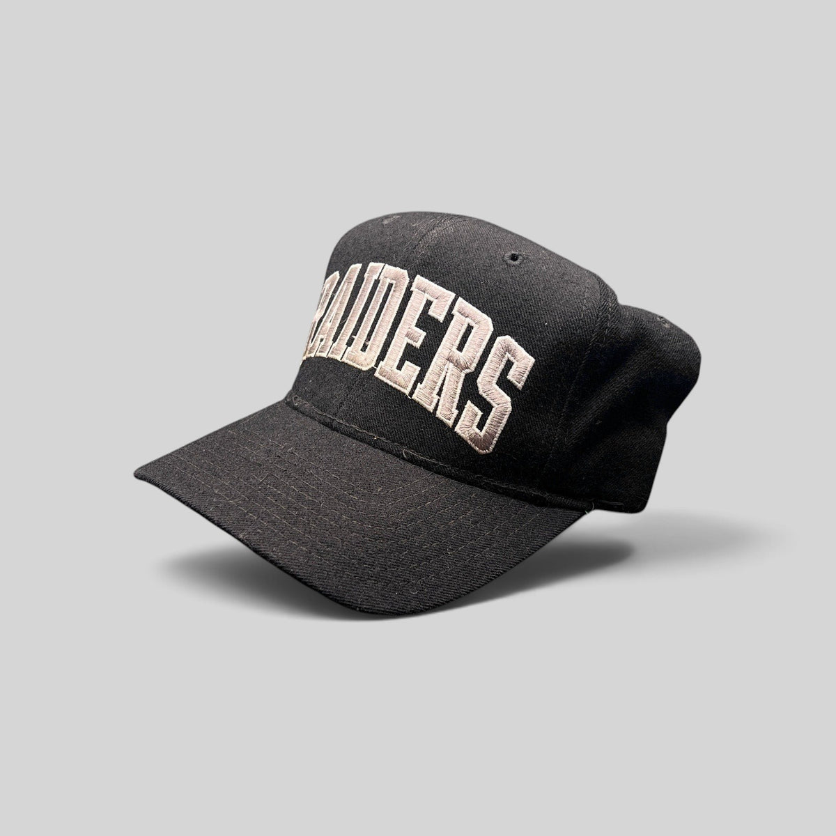 Raree Finds vintage 1990s Starter Los Angeles Raiders wool snapback hat in black with silver arch logo embroidery