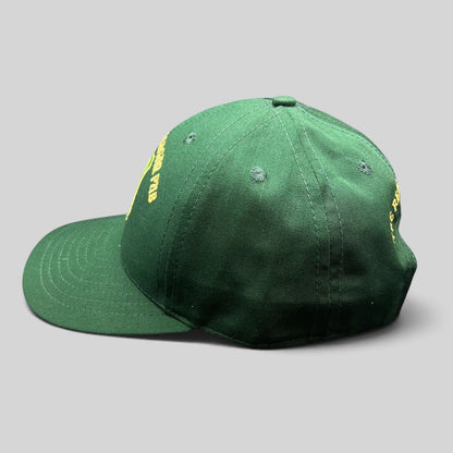 Raree Finds vintage green snapback hat featuring gold embroidered Ronald Reagan Pub crest from Ballyporeen, Ireland.