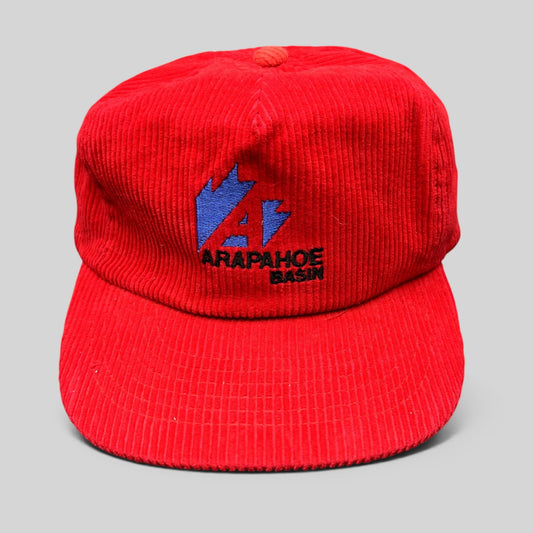 Raree Finds vintage red corduroy Arapahoe Basin ski hat with embroidered blue and black mountain logo on front