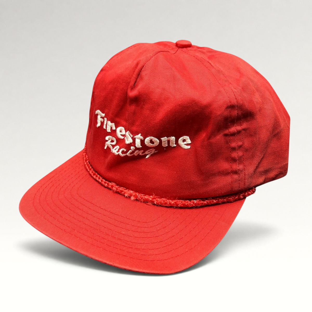Raree Finds vintage red Firestone Racing snapback hat with white embroidered logo and braided rope brim detail