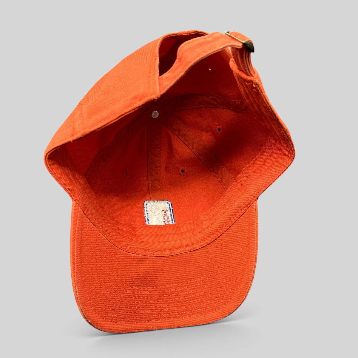 Raree Finds vintage red PGA Tour cotton strapback hat showing the interior construction and adjustable metal buckle