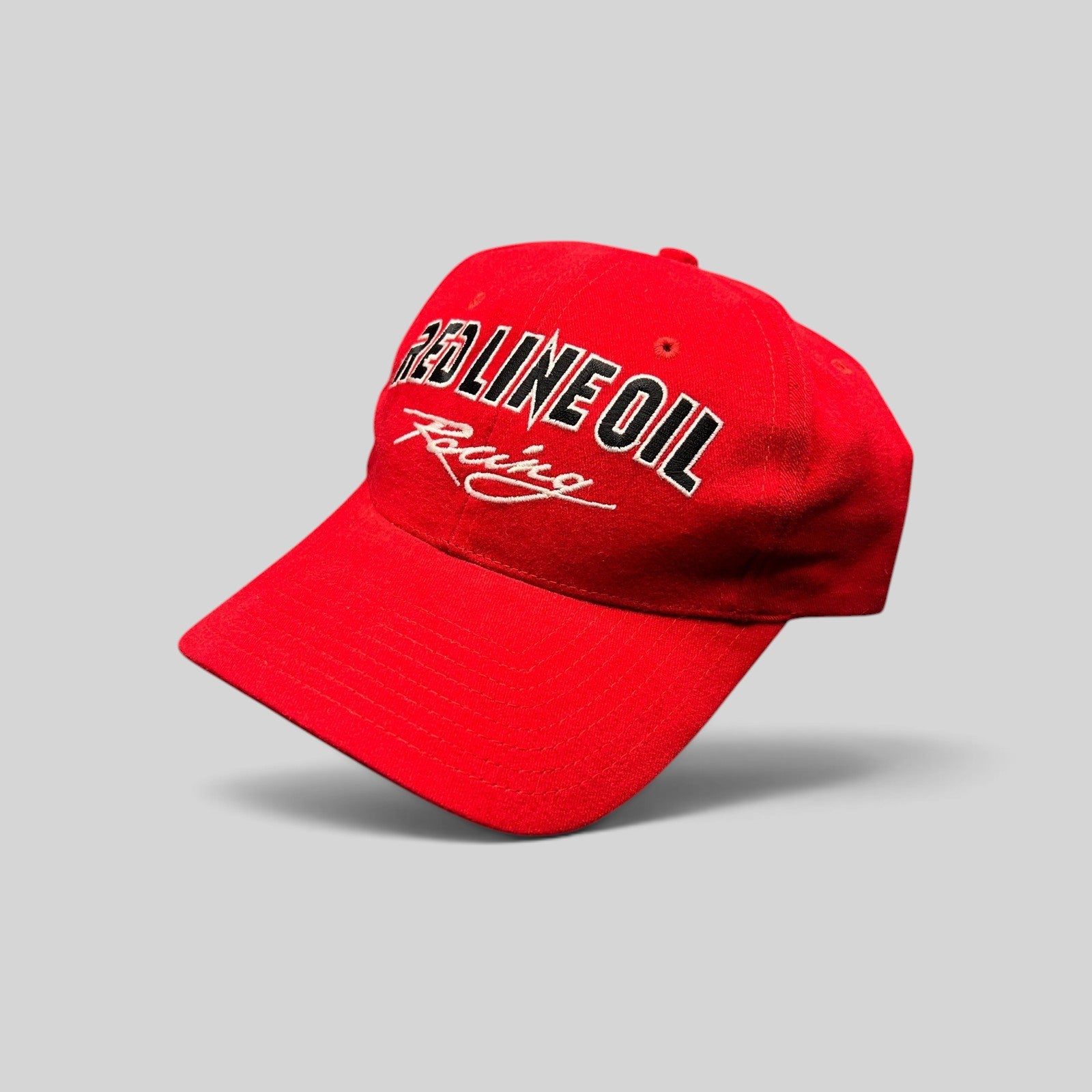Raree Finds vintage red Red Line Oil Racing snapback hat with black and white embroidery on a structured crown