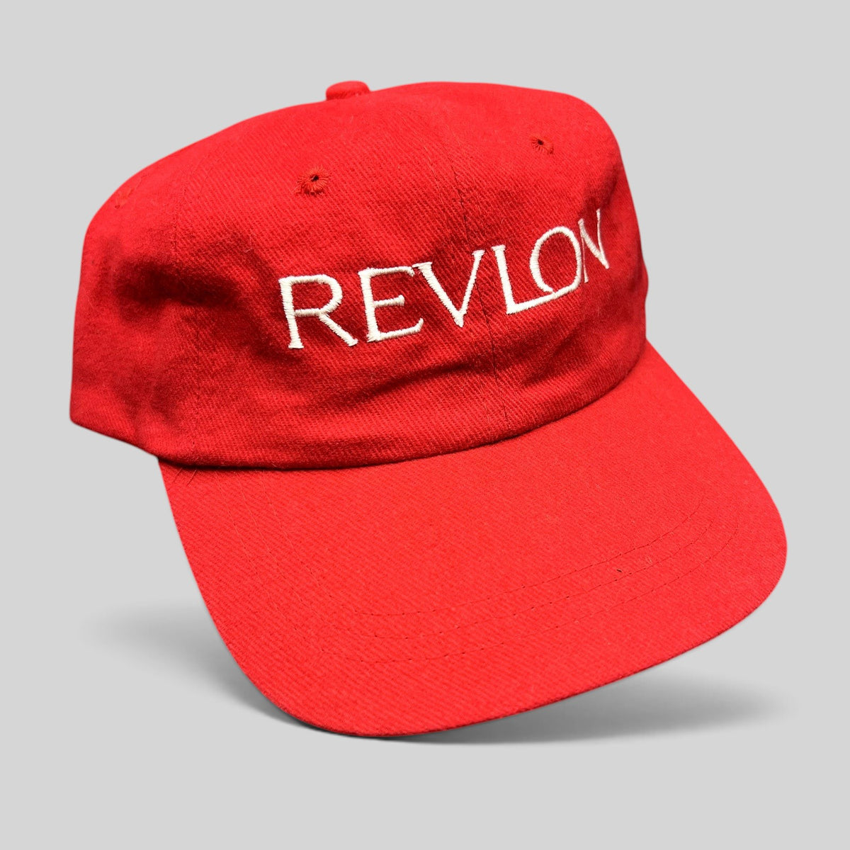 Raree Finds vintage bright red Revlon promotional strapback hat with white embroidered lettering on the front panel
