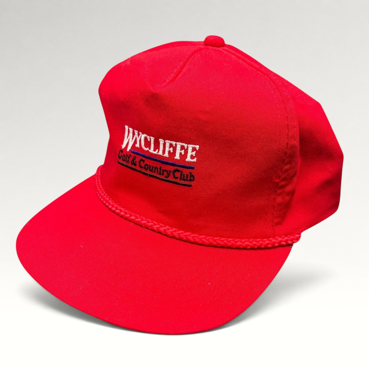 Raree Finds vintage red snapback hat with white Wycliffe Golf & Country Club embroidery and decorative rope trim.