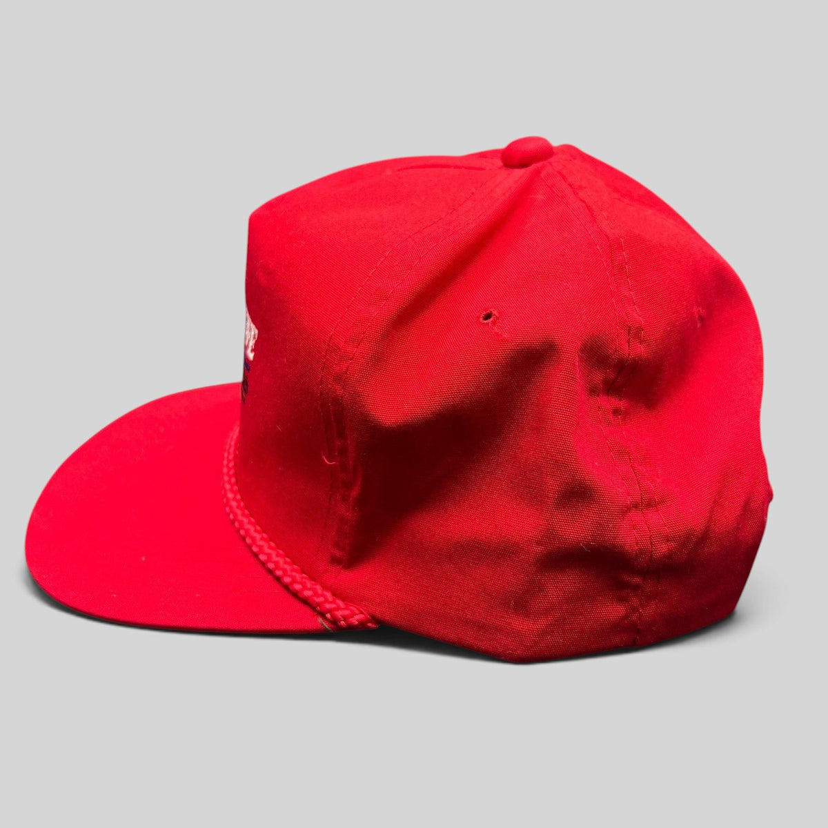 Raree Finds vintage red snapback hat with rope detail and embroidered logo, side view of cotton blend cap
