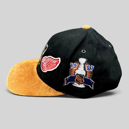 Raree Finds vintage 1997 Detroit Red Wings Stanley Cup champions strapback hat with black crown and tan suede brim.