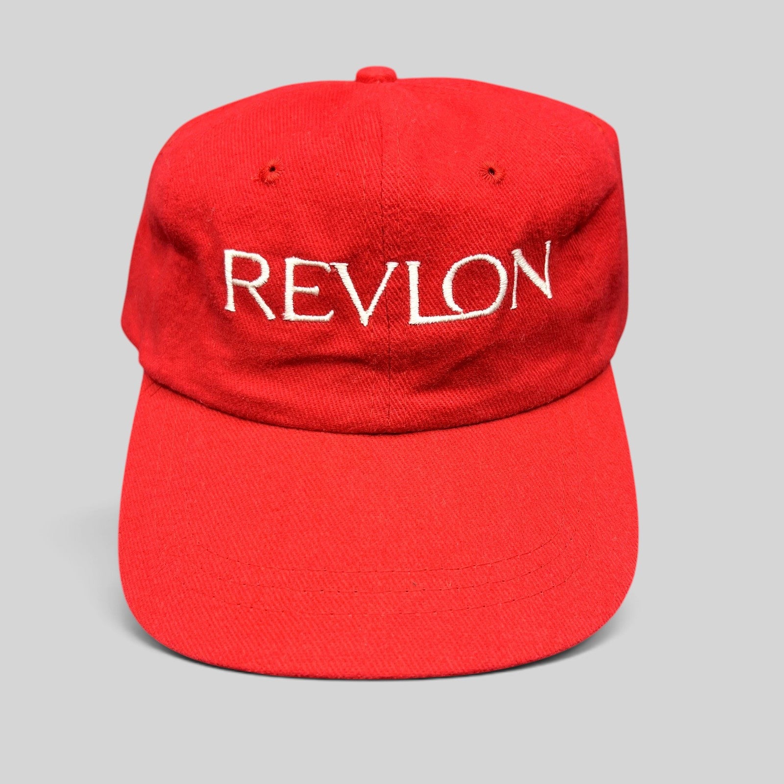 Raree Finds vintage red Revlon promotional strapback hat with white embroidered logo on front panel
