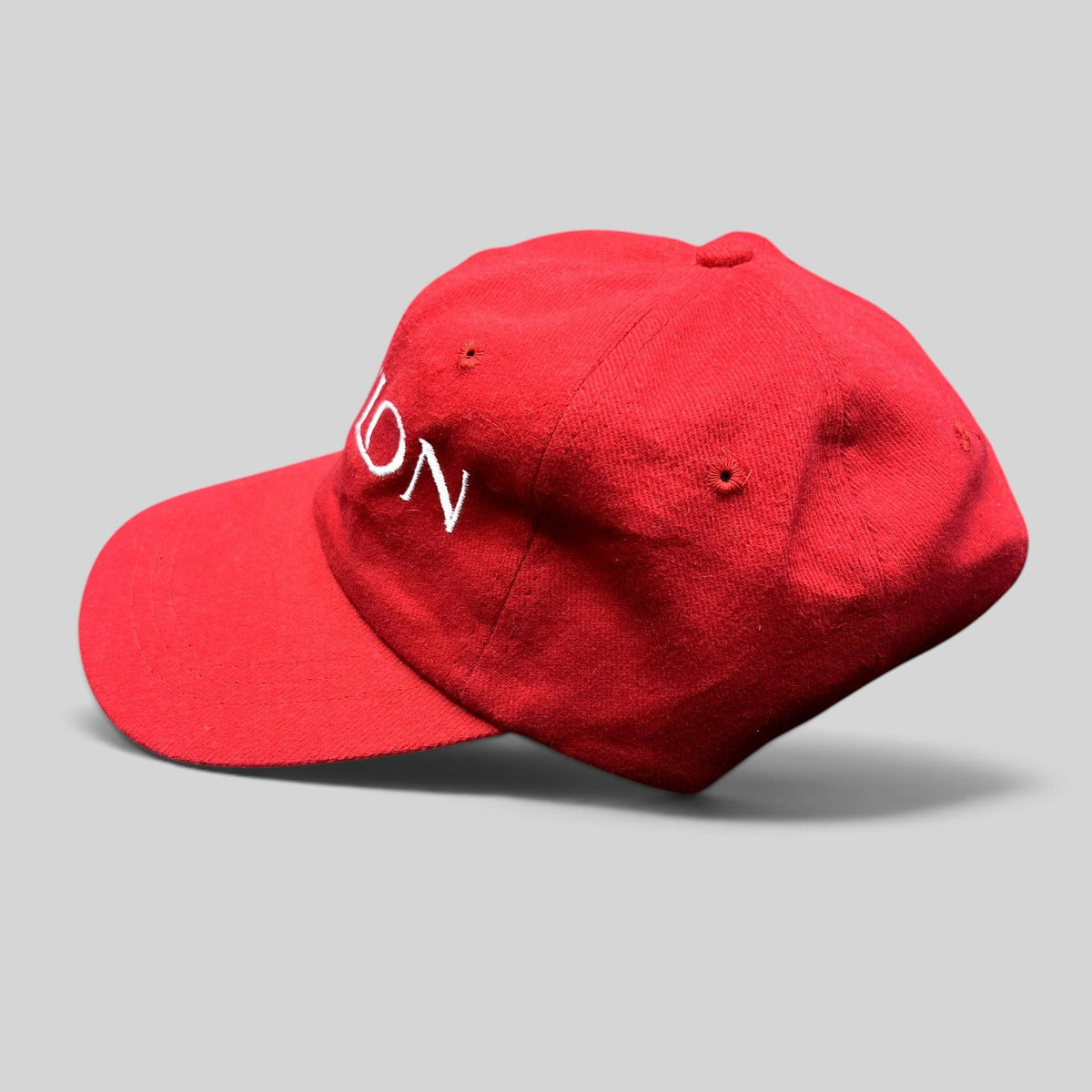 Raree Finds vintage red Revlon promotional strapback hat with white embroidered lettering on the front panel