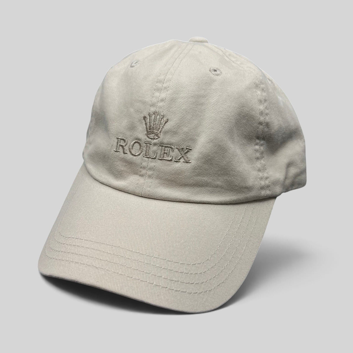 Raree Finds vintage khaki cotton Rolex strapback golf hat with embroidered crown logo on a neutral beige cap