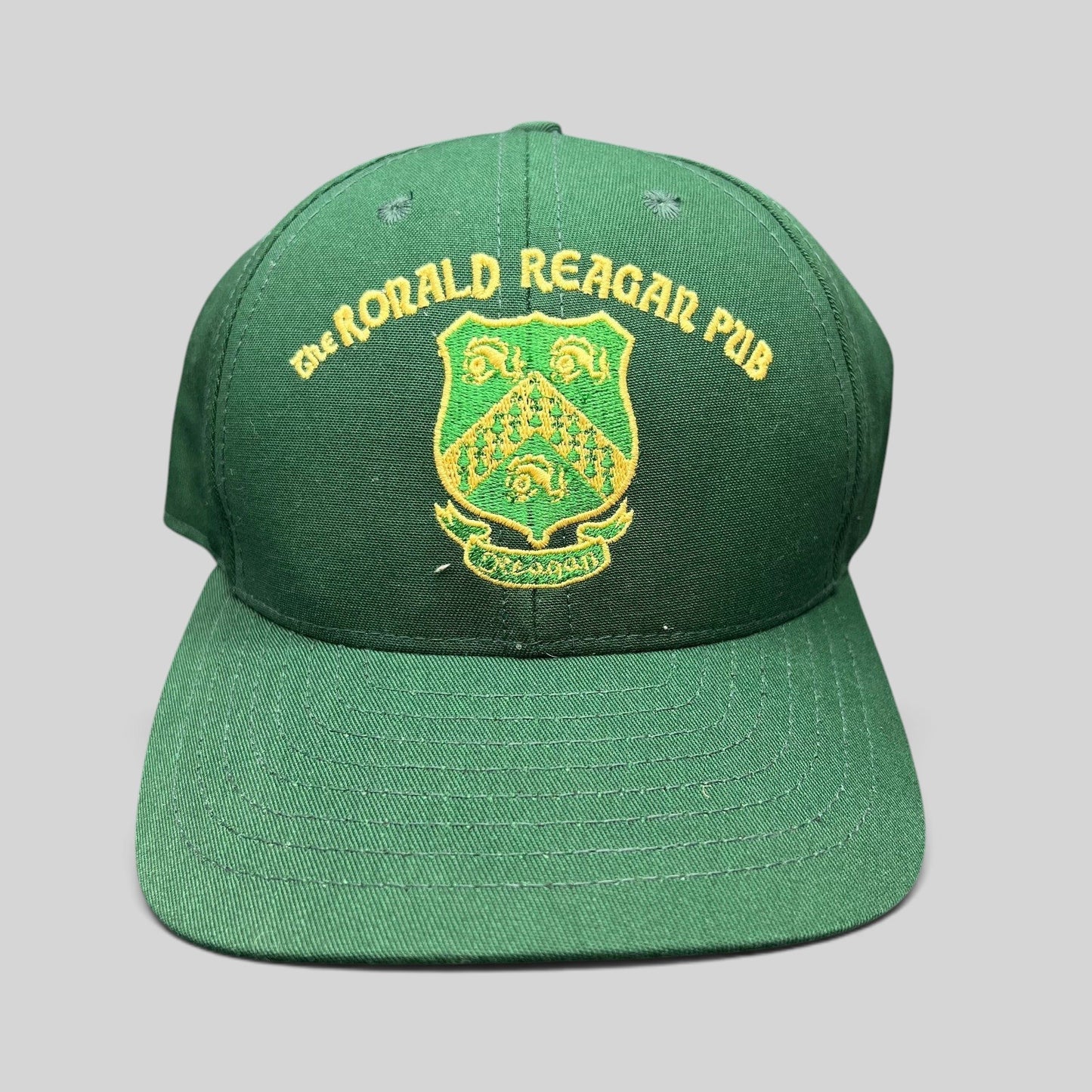 Raree Finds vintage green snapback hat with gold embroidered The Ronald Reagan Pub crest from Ballyporeen, Ireland.