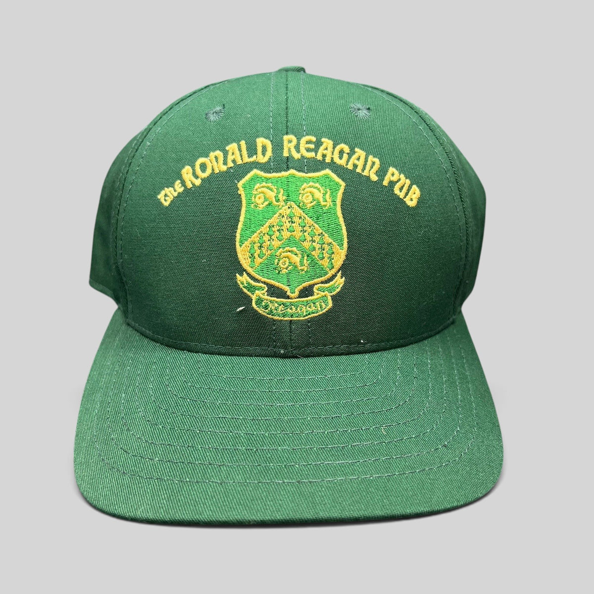 Raree Finds vintage green snapback hat with gold embroidered The Ronald Reagan Pub crest from Ballyporeen, Ireland.