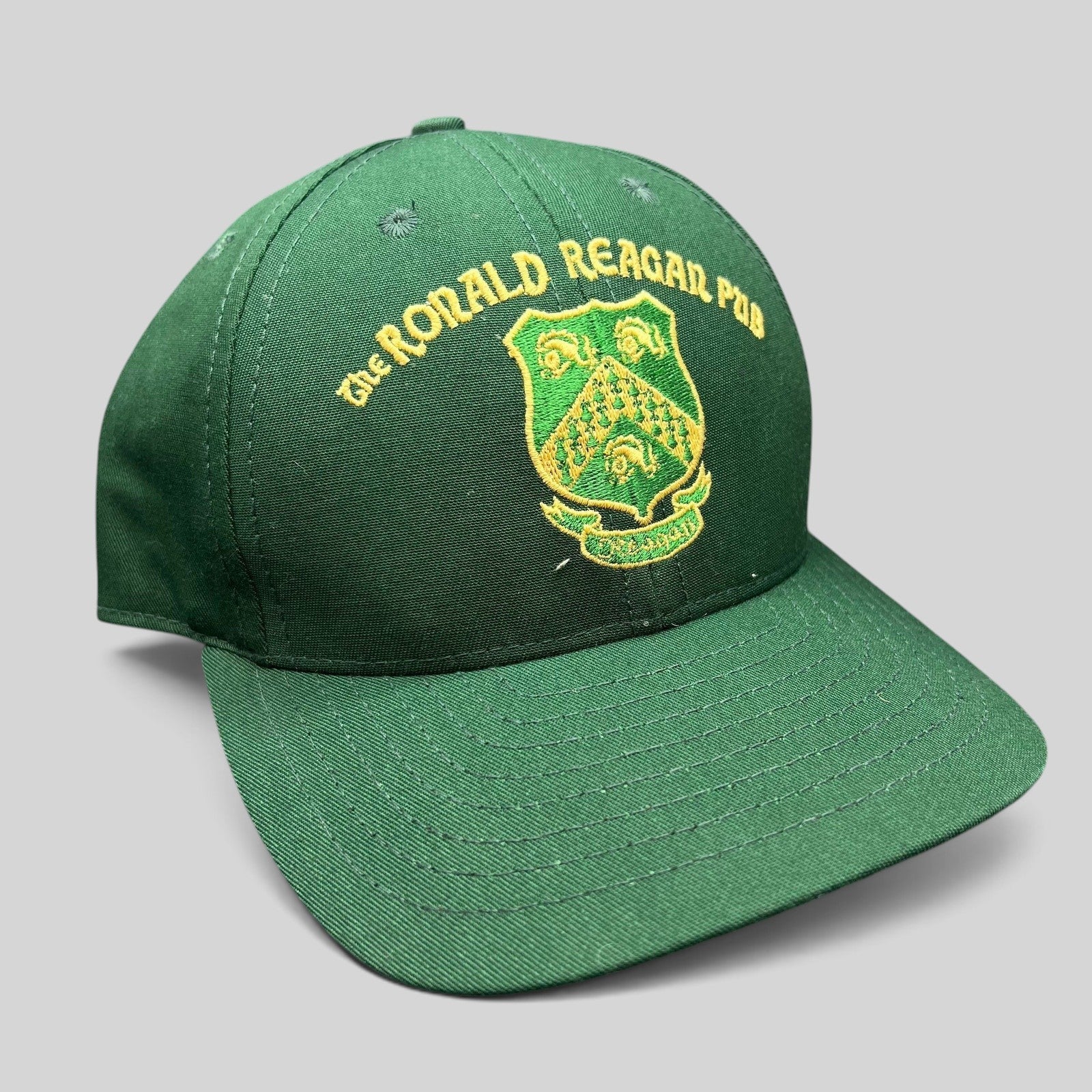 Raree Finds vintage green snapback hat featuring The Ronald Reagan Pub embroidered gold crest from Ballyporeen Ireland.
