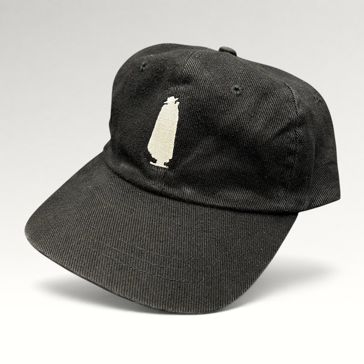 Raree Finds vintage 1990s black cotton dad cap featuring an embroidered white Sandeman port wine bottle logo