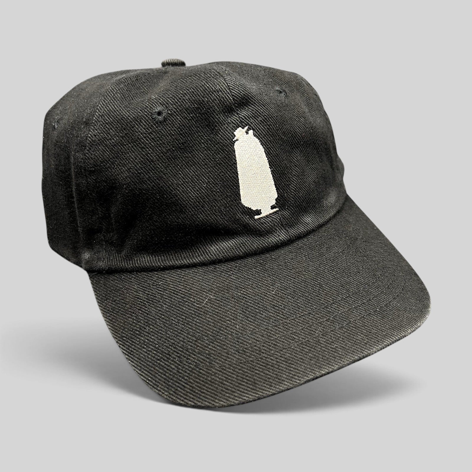 Raree Finds vintage 1990s black cotton strapback hat with an embroidered white Sandeman port wine bottle logo