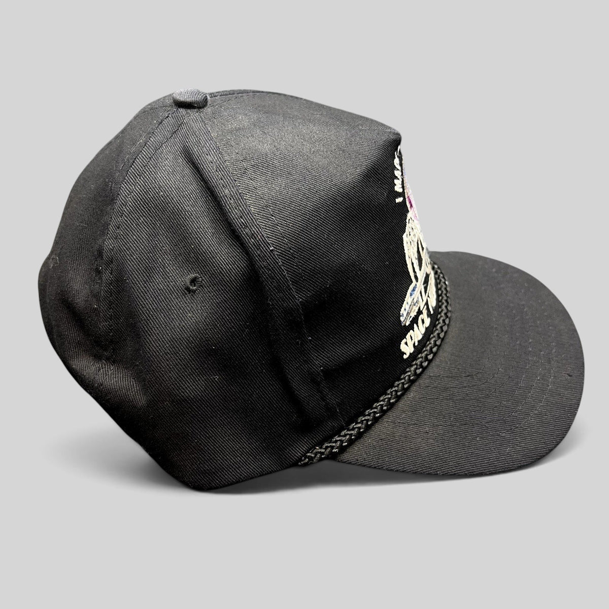 Raree Finds vintage 90s black snapback hat featuring a colorful Seattle Space Needle embroidery and braided rope brim.