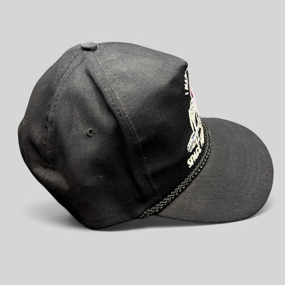 Raree Finds vintage 90s black snapback hat featuring a colorful Seattle Space Needle embroidery and braided rope brim.