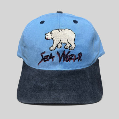 Raree Finds vintage 1990s SeaWorld snapback hat with embroidered polar bear graphic on a light blue and navy crown.