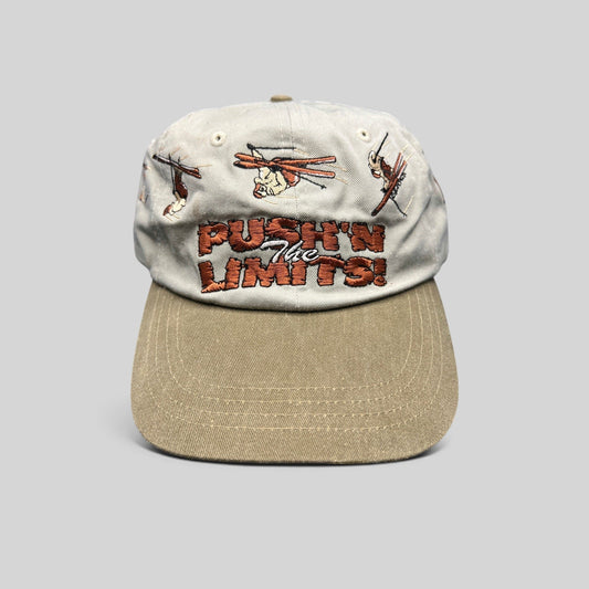 Raree Finds vintage 90s Attitude brand strapback hat with stone crown, olive brim, and embroidered skier graphics.