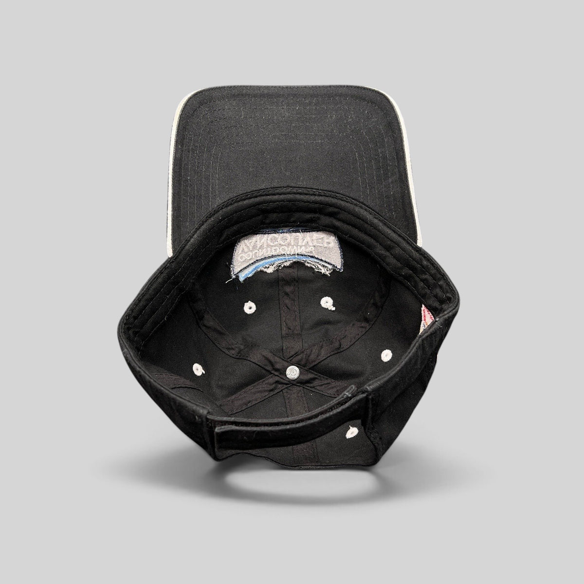 Raree Finds vintage black US Ski Team Vancouver countdown cotton strapback hat, interior view showing construction.