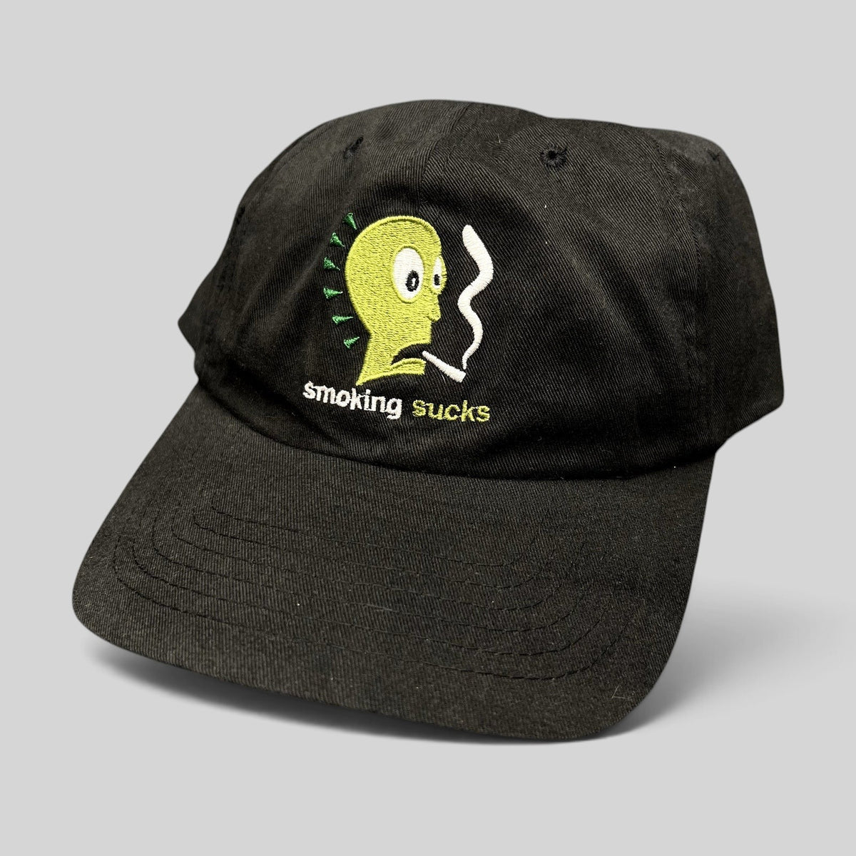 Raree Finds vintage black snapback hat with Smoking Sucks embroidered cartoon character graphic in green and white.