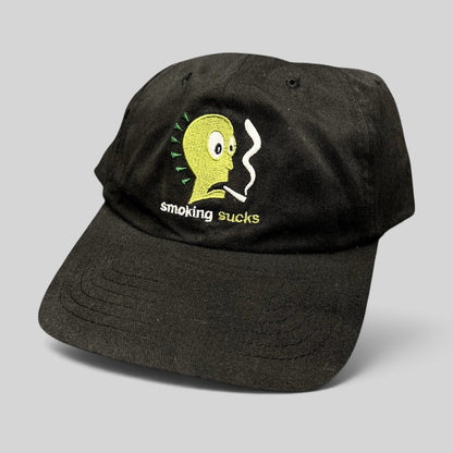 Raree Finds vintage black snapback hat with Smoking Sucks embroidered cartoon character graphic in green and white.
