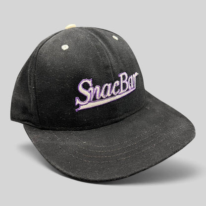 Raree Finds vintage 90s black snapback hat with purple SnacBar script embroidery and a structured front panel.