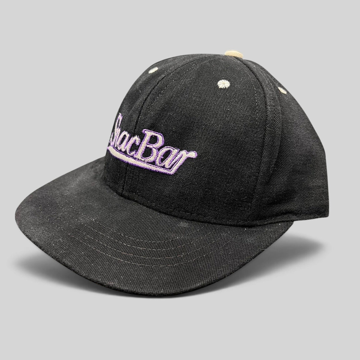 Raree Finds vintage 90s black snapback hat with purple Snack Bar script embroidery and a light gray brim