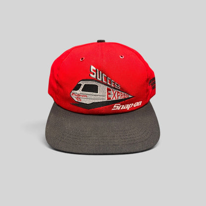 Raree Finds vintage 1993 Snap-on Success Express snapback hat with red crown, black brim, and embroidered train graphic.