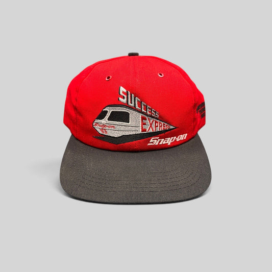 Raree Finds vintage 1993 Snap-on Success Express snapback hat with red crown, black brim, and embroidered train graphic.