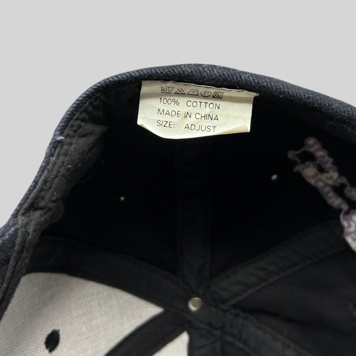 Raree Finds vintage Jimmy V snapback hat interior tag showing 100 percent cotton material and adjustable sizing