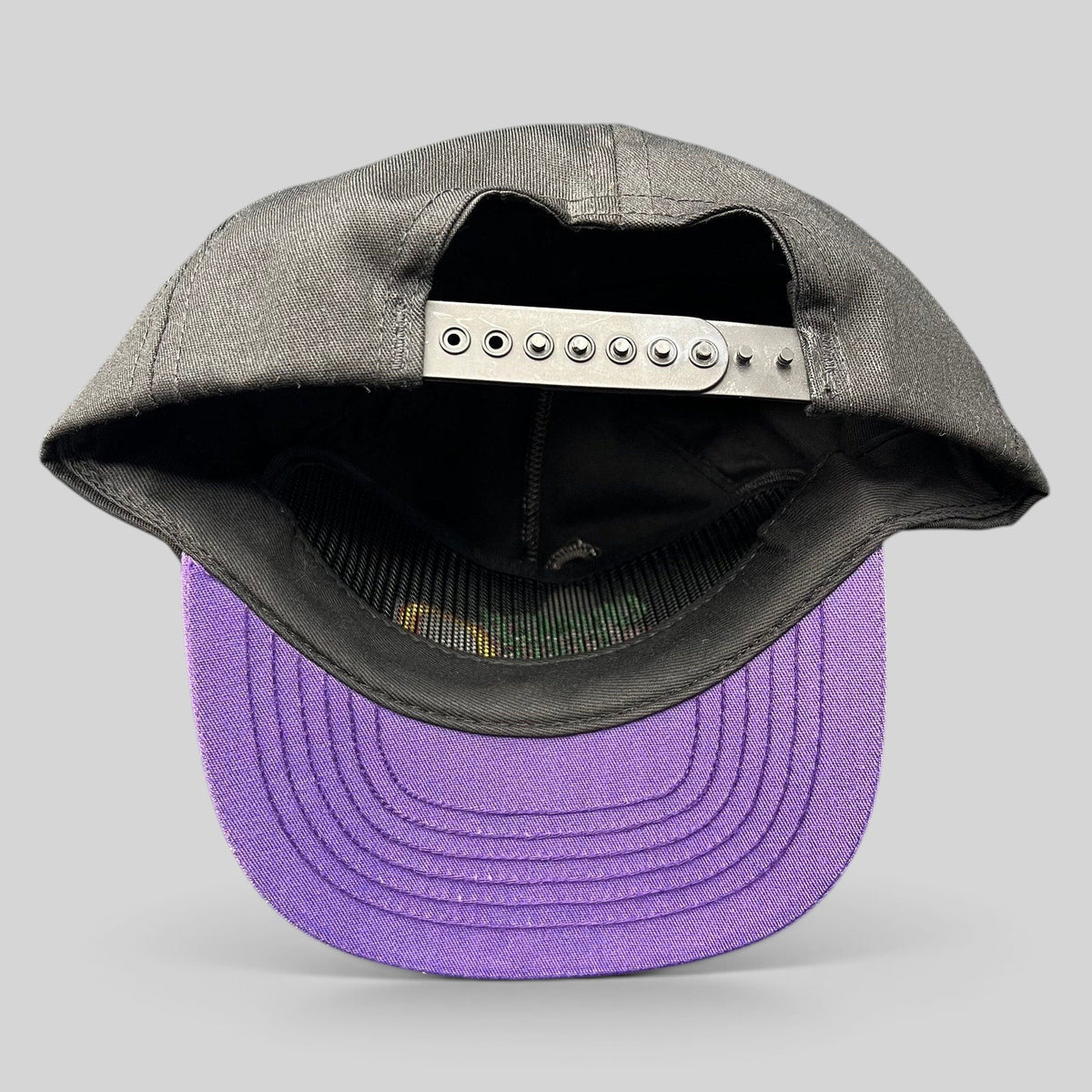 Raree Finds vintage Competitor snapback hat with black crown, purple brim, and adjustable plastic strap back view