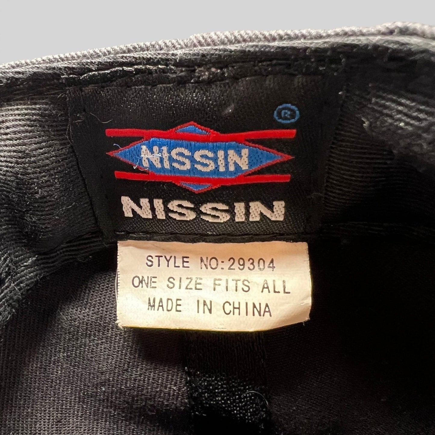Raree Finds vintage snapback hat interior tag showing Nissin branding, style number 29304, and one size label.