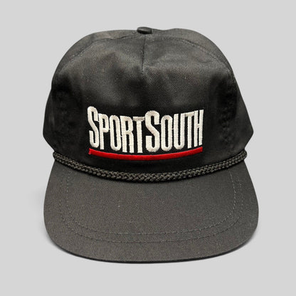 Raree Finds vintage SportSouth black rope strapback hat with white and red embroidered logo on a grey background