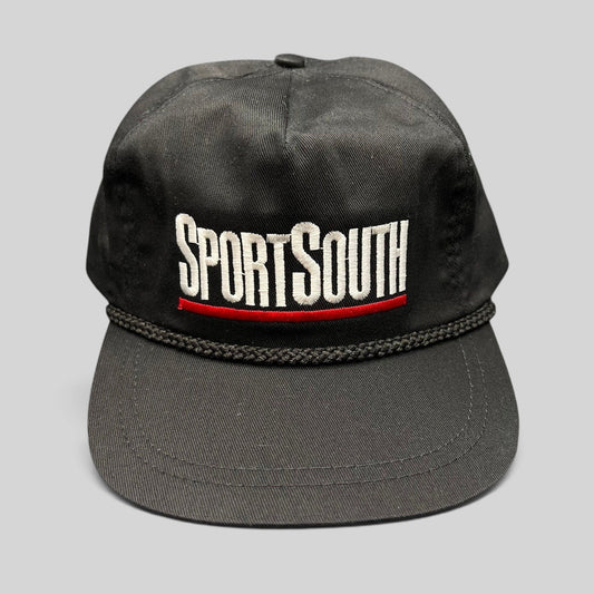 Raree Finds vintage SportSouth black rope strapback hat with white and red embroidered logo on a grey background