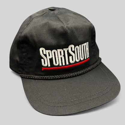 Raree Finds vintage black SportSouth rope strapback hat with white and red embroidery and a classic green underbrim.