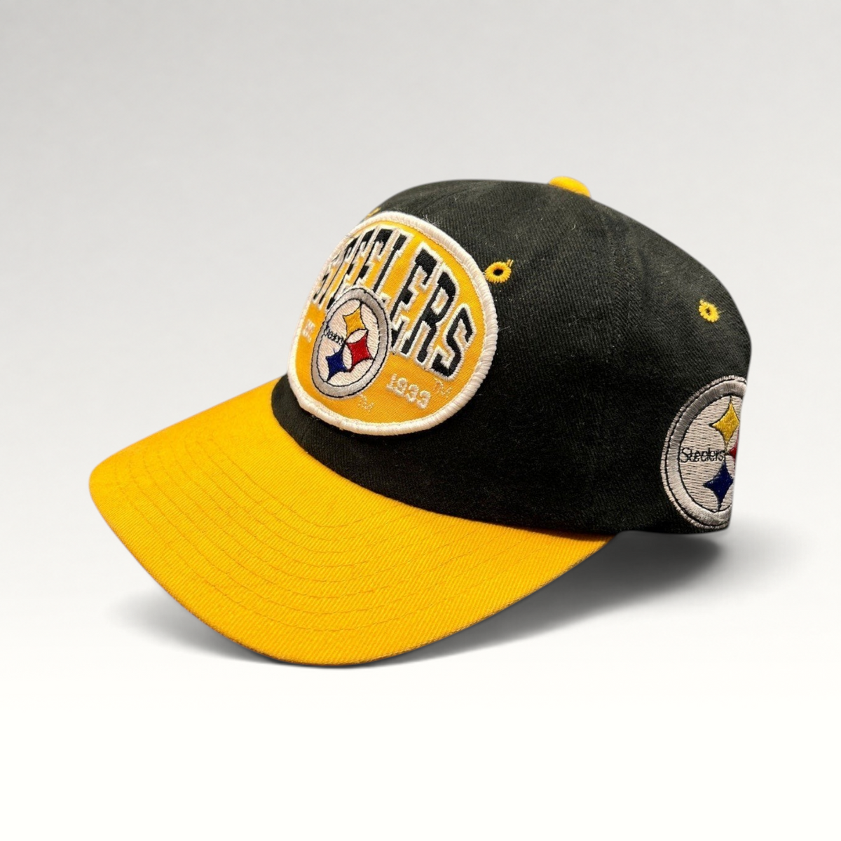 Raree Finds vintage 1990s Pittsburgh Steelers snapback hat with black crown, gold visor, and embroidered team patch.