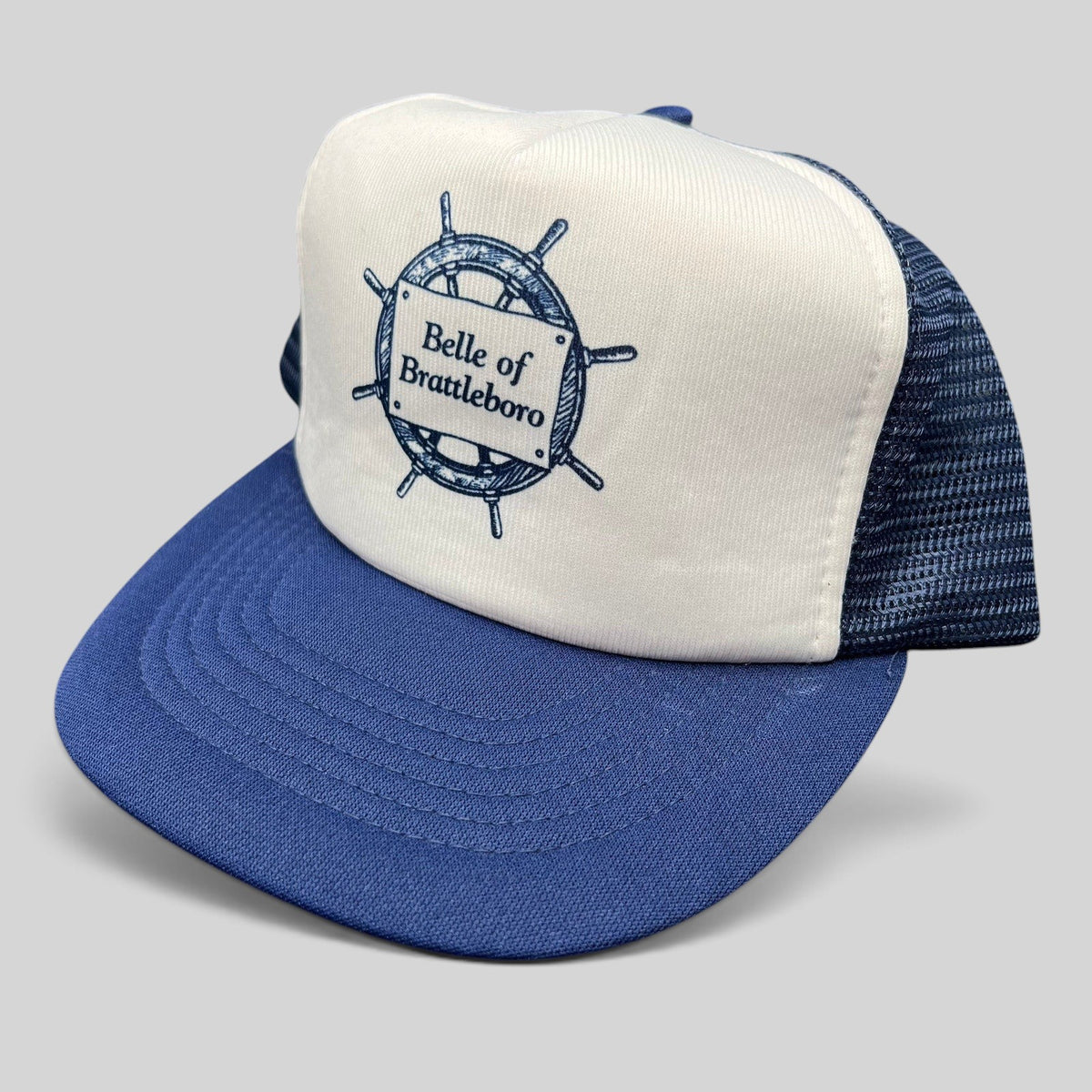Raree Finds vintage Sunbelt trucker hat with white foam front, navy mesh back, and Belle of Brattleboro ship graphic.