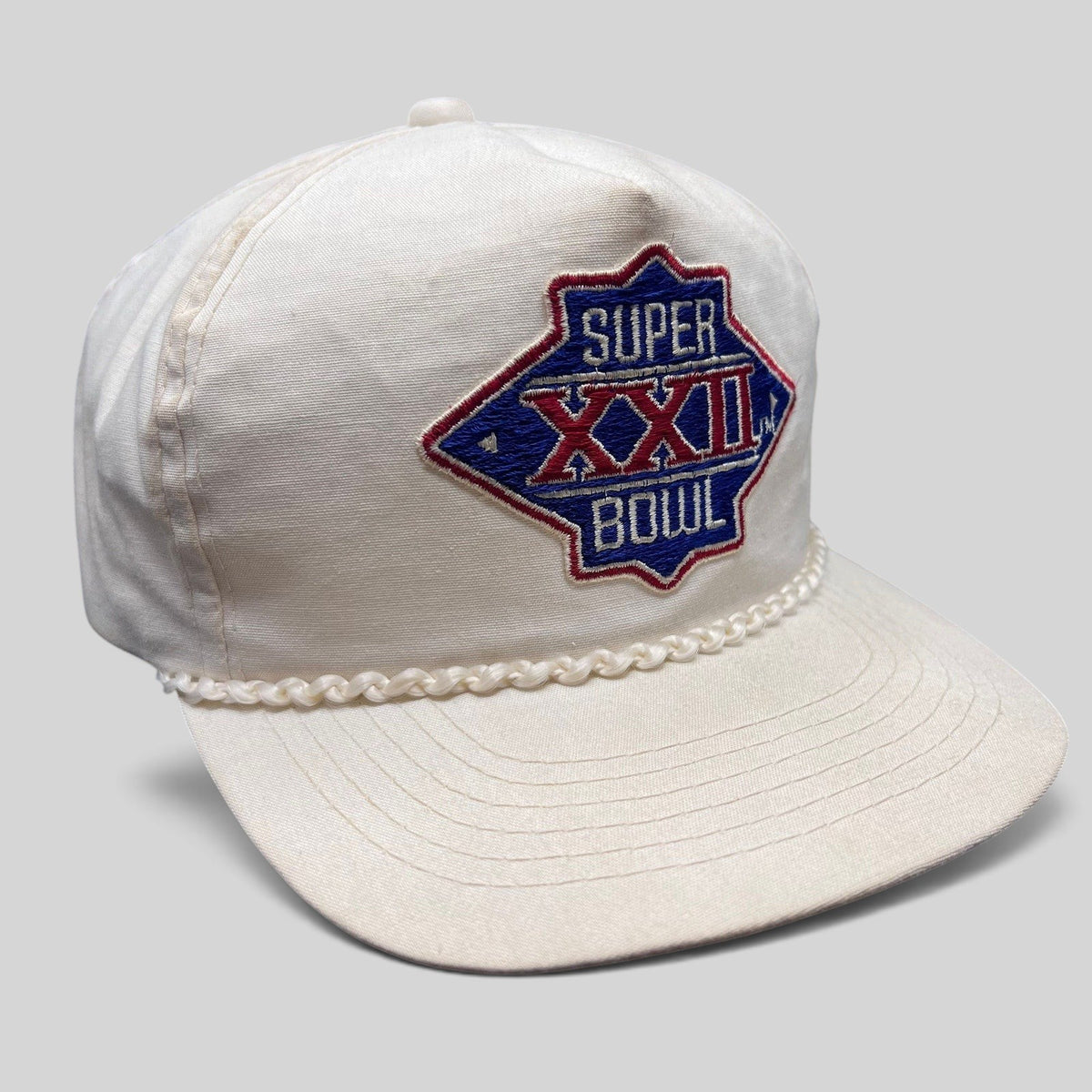 Raree Finds vintage 1988 Super Bowl XXII white snapback hat with braided rope trim and embroidered logo.