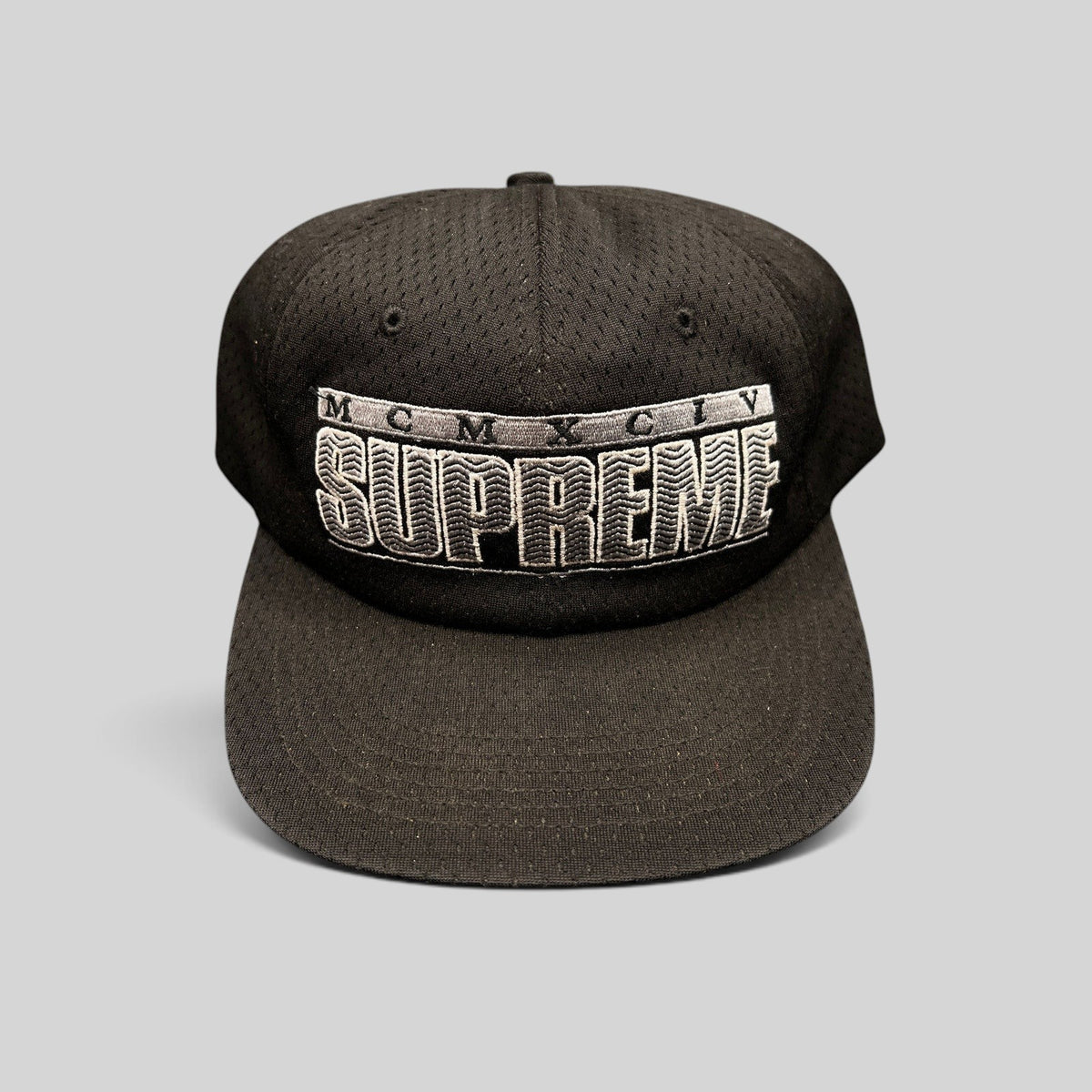 Raree Finds vintage black Supreme mesh snapback hat featuring raised 3D MCMXCIV embroidery and adjustable closure.
