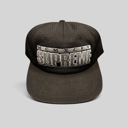 Raree Finds vintage black Supreme mesh snapback hat featuring raised 3D MCMXCIV embroidery and adjustable closure.