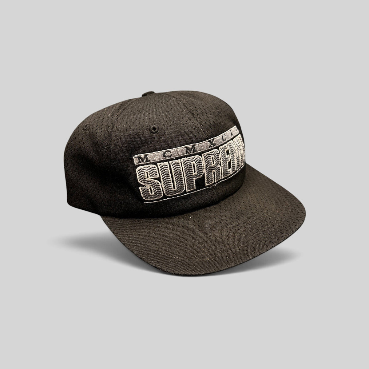 Raree Finds vintage black Supreme MCMXCIV mesh snapback hat with 3D white embroidered logo and adjustable closure.